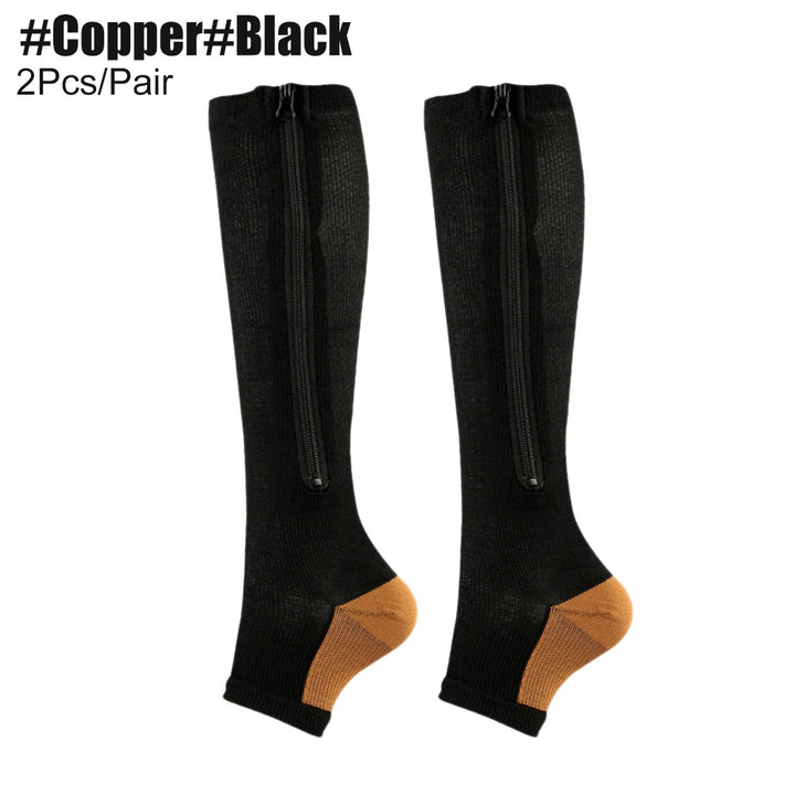 Black knee-high socks with gold toes and heels on a white background