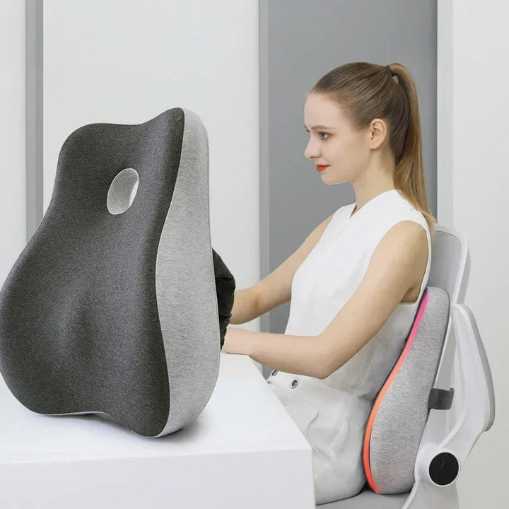 Woman using a gray and black cushion with a white background
