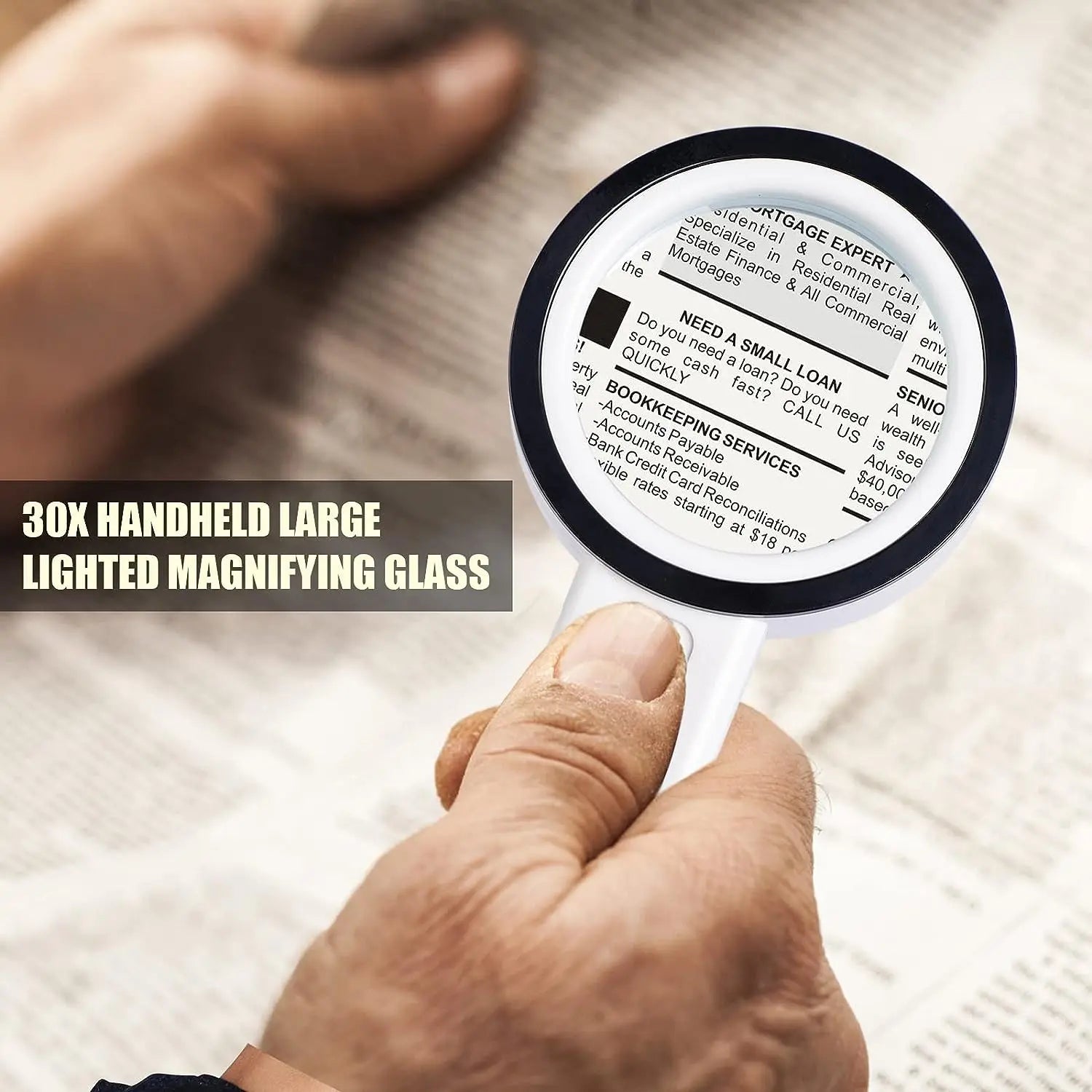 Handheld magnifying glass held by a person over printed text on paper.