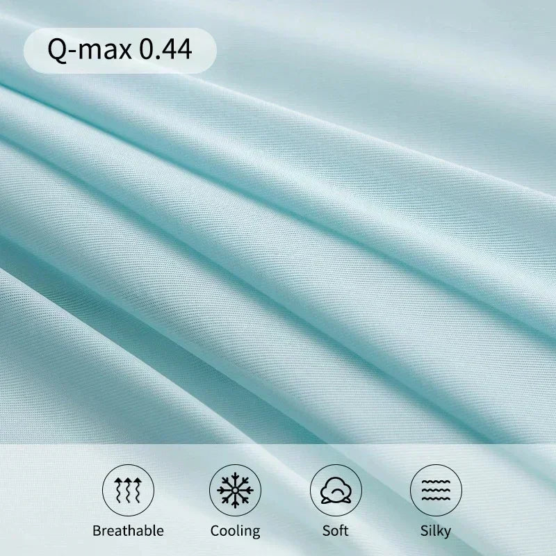 Light blue fabric with 'Q-max 0.44' text and icons indicating breathable, cooling, soft, and silky properties.