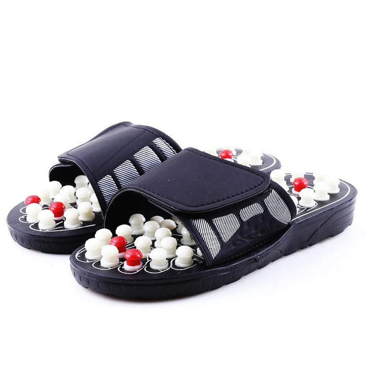 Black massage sandals with white and red beads on a white background