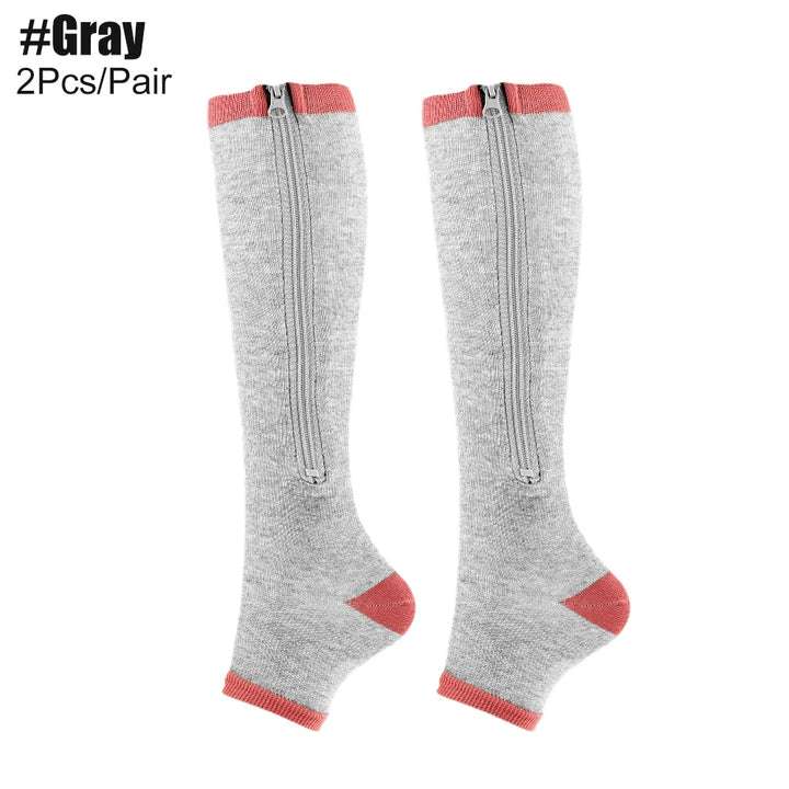 Gray knee-high socks with red accents and zippers on a white background